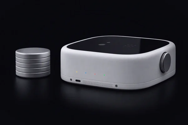 A short stack of plain metal discs beside a larger compute sled with four coloured lights
